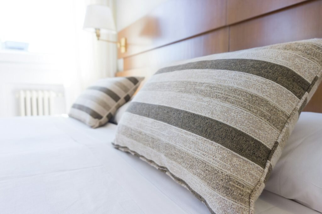 Freshly made bed with clean linens – part of effective Airbnb cleaning management.